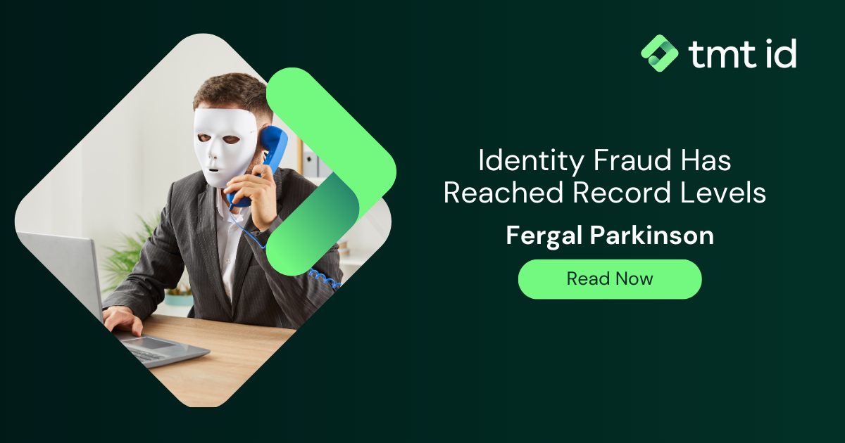 Man wearing a mask while working on a laptop, highlighting a report on online frauds and scams.