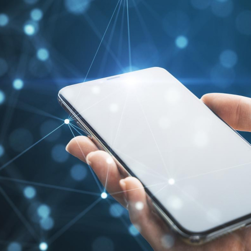 Hand holding a smartphone with illuminated network connections on a blue background.